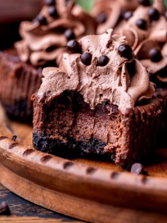 Bite missing from mini chocolate cheesecakes.