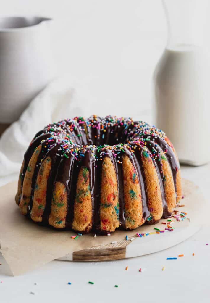 Confetti bundt cake with chocolate on top.
