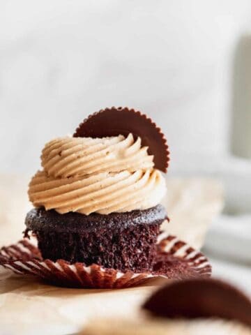 Wrapper taken off cupcake on platter.