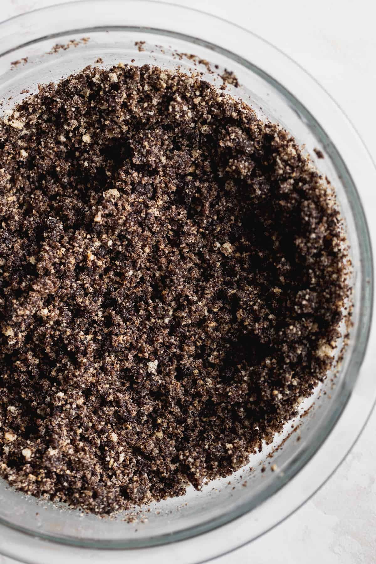 Oreo crumbs in a glass bowl.