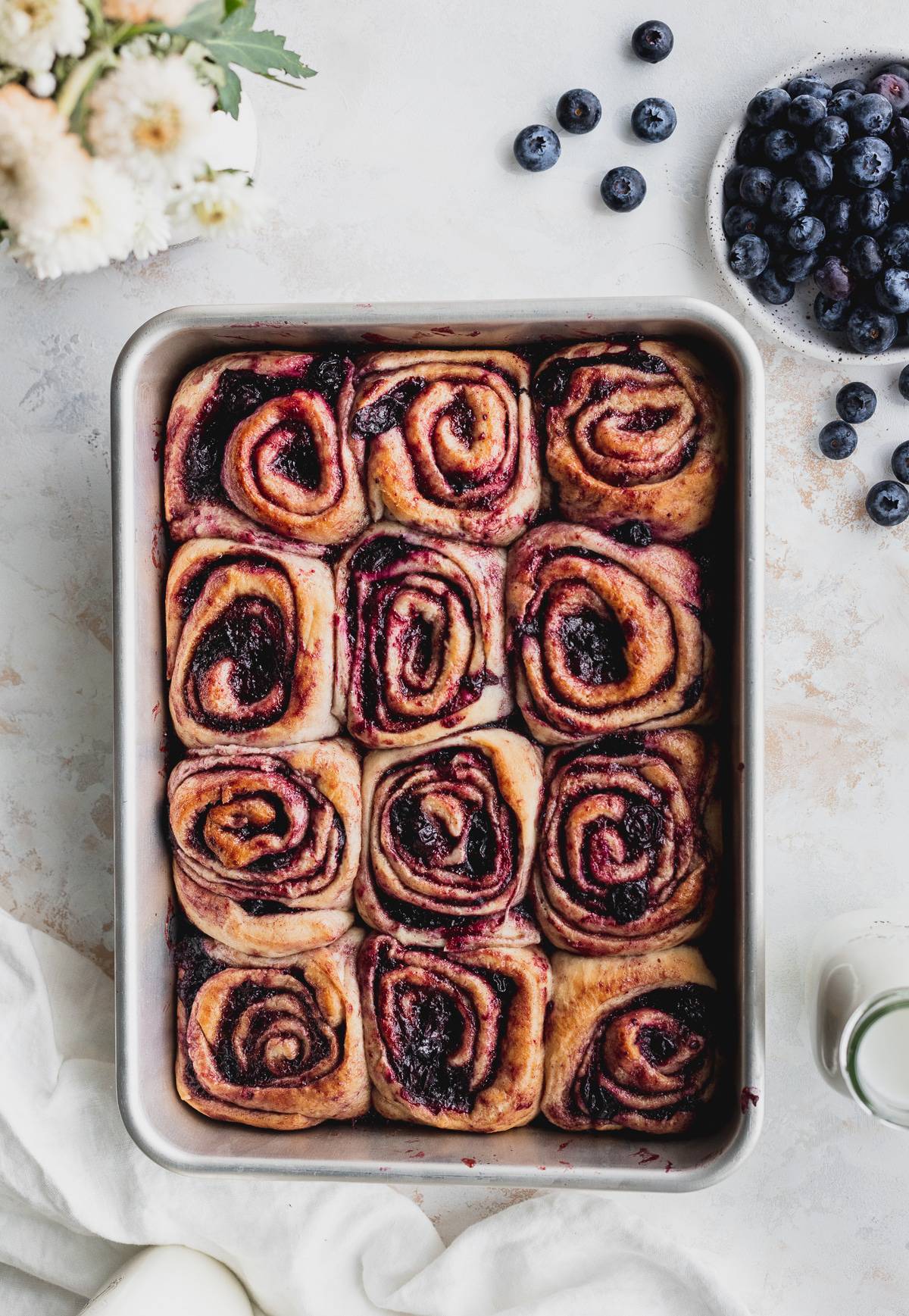 Blueberry cinnamon rolls with no frosting in the pan.