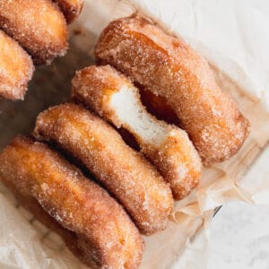 Close up of cinnamon sugar doughnuts in a basket.
