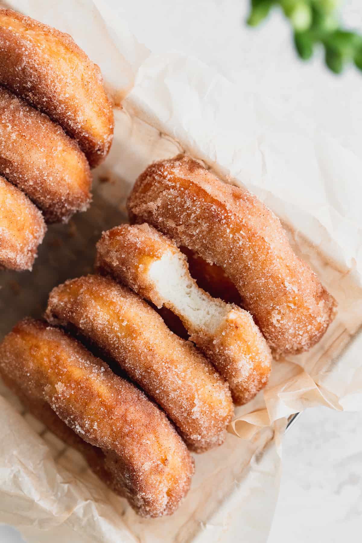 Close up of cinnamon sugar doughnuts in a basket.