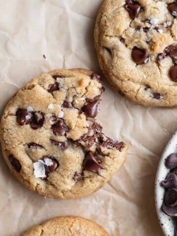 Close up of brown butter chocolate chip cookies with a bite missing.