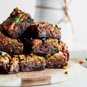 Stack of monster cookie brownie bars.