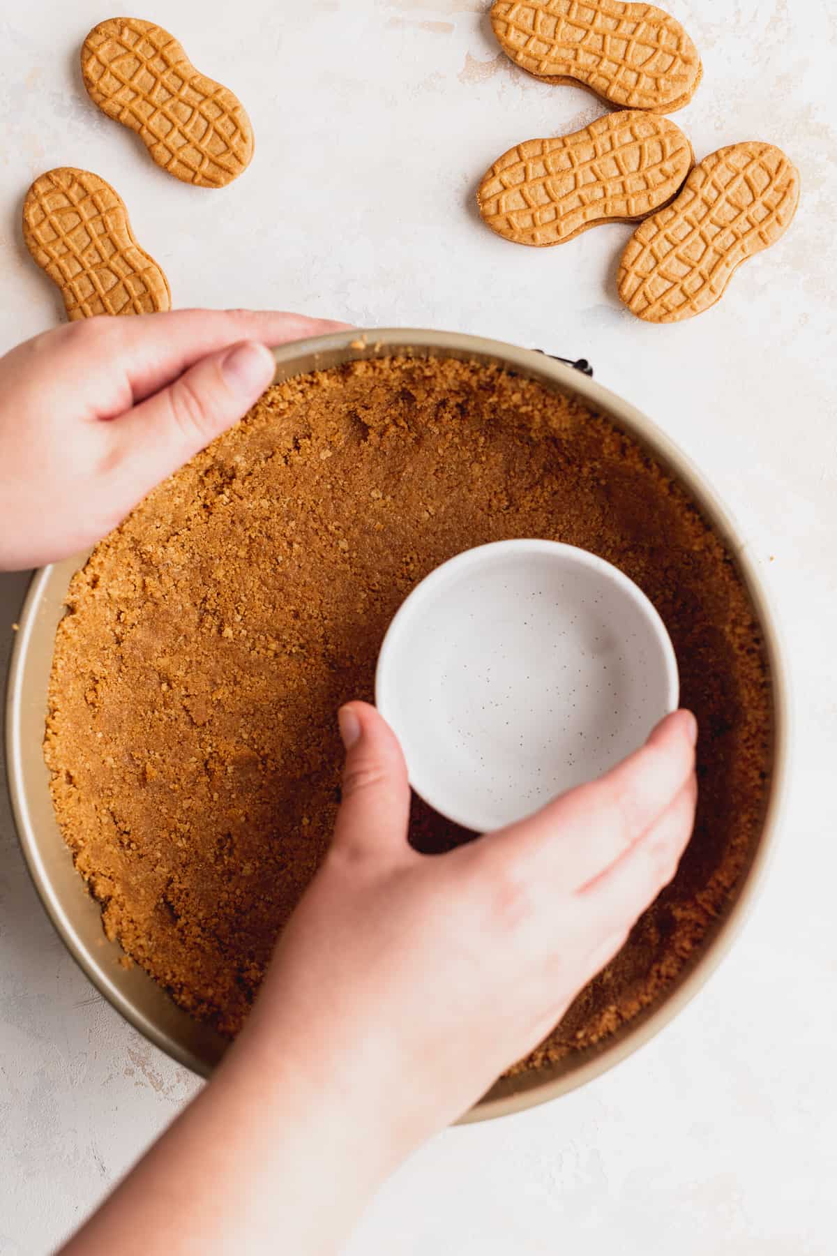 Pressing crumbs into pan.