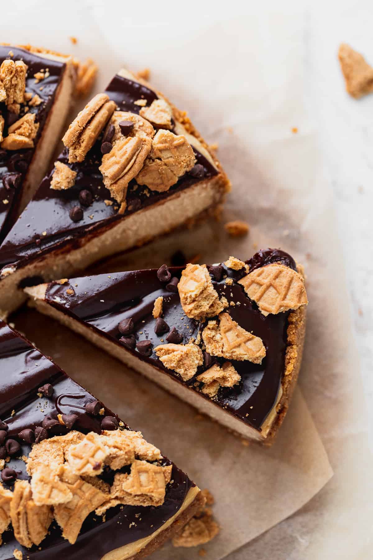 This peanut butter cheesecake cut into slices with one pulled away.