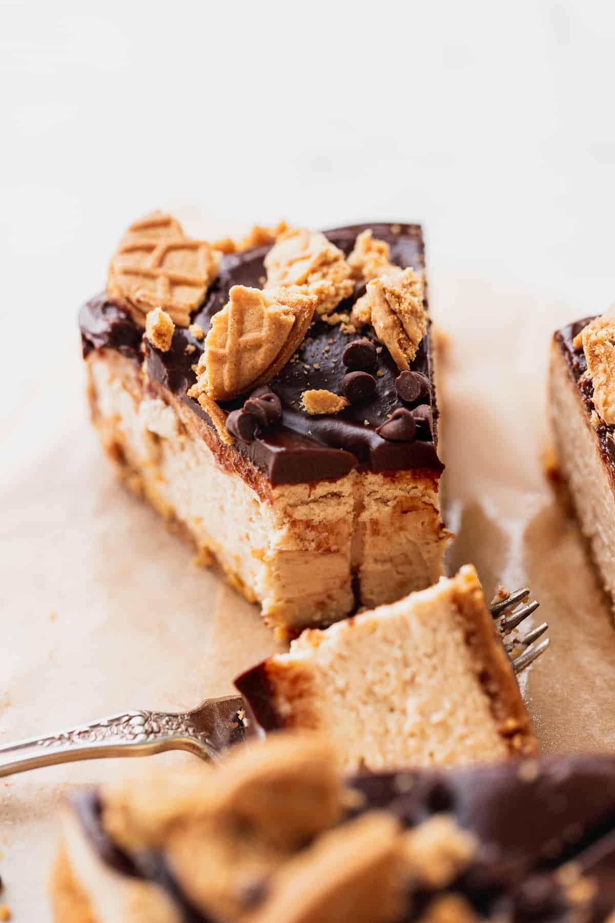 Close up of peanut butter cheesecake with a bite missing.