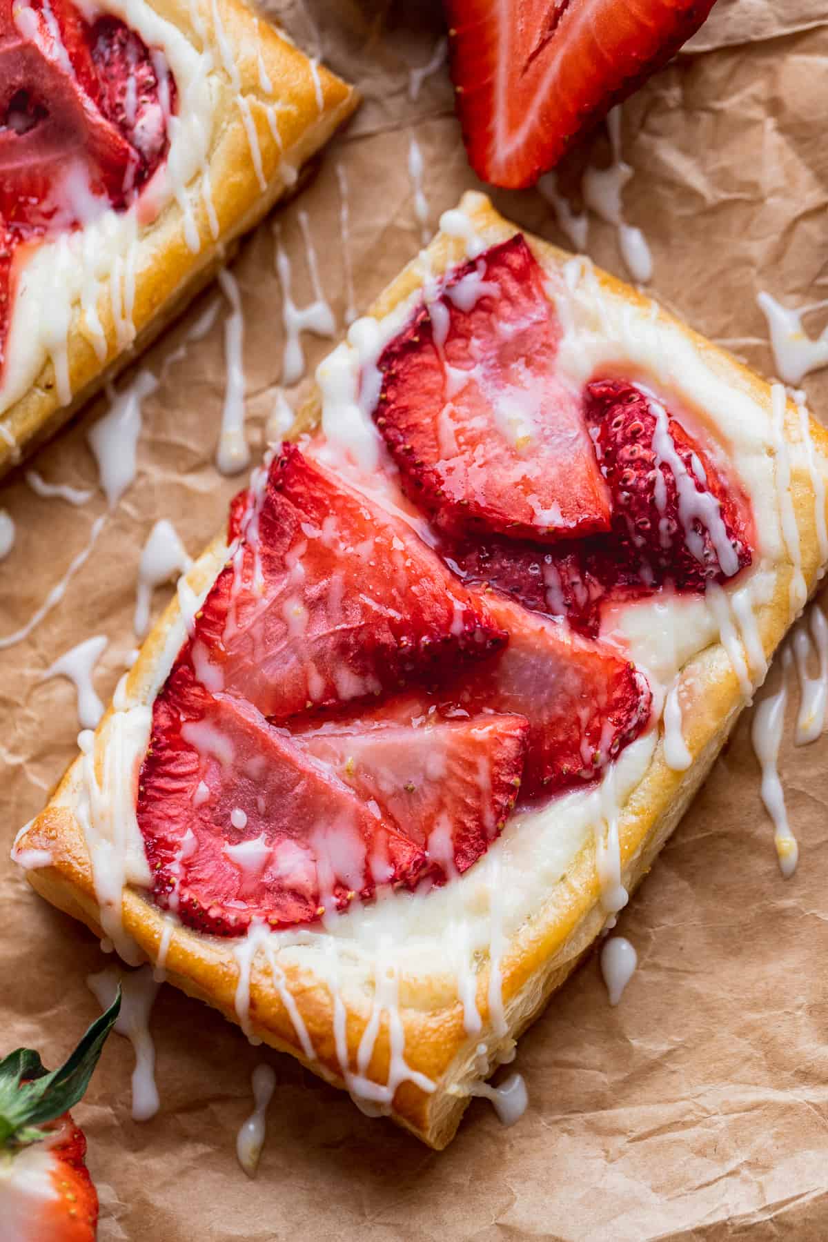 Strawberry danish close up with drizzle on top.