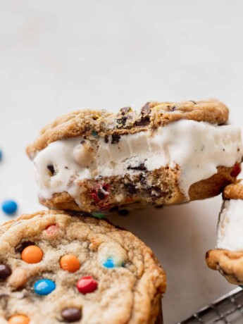 Bite missing from m&m cookie ice cream sandwiches.
