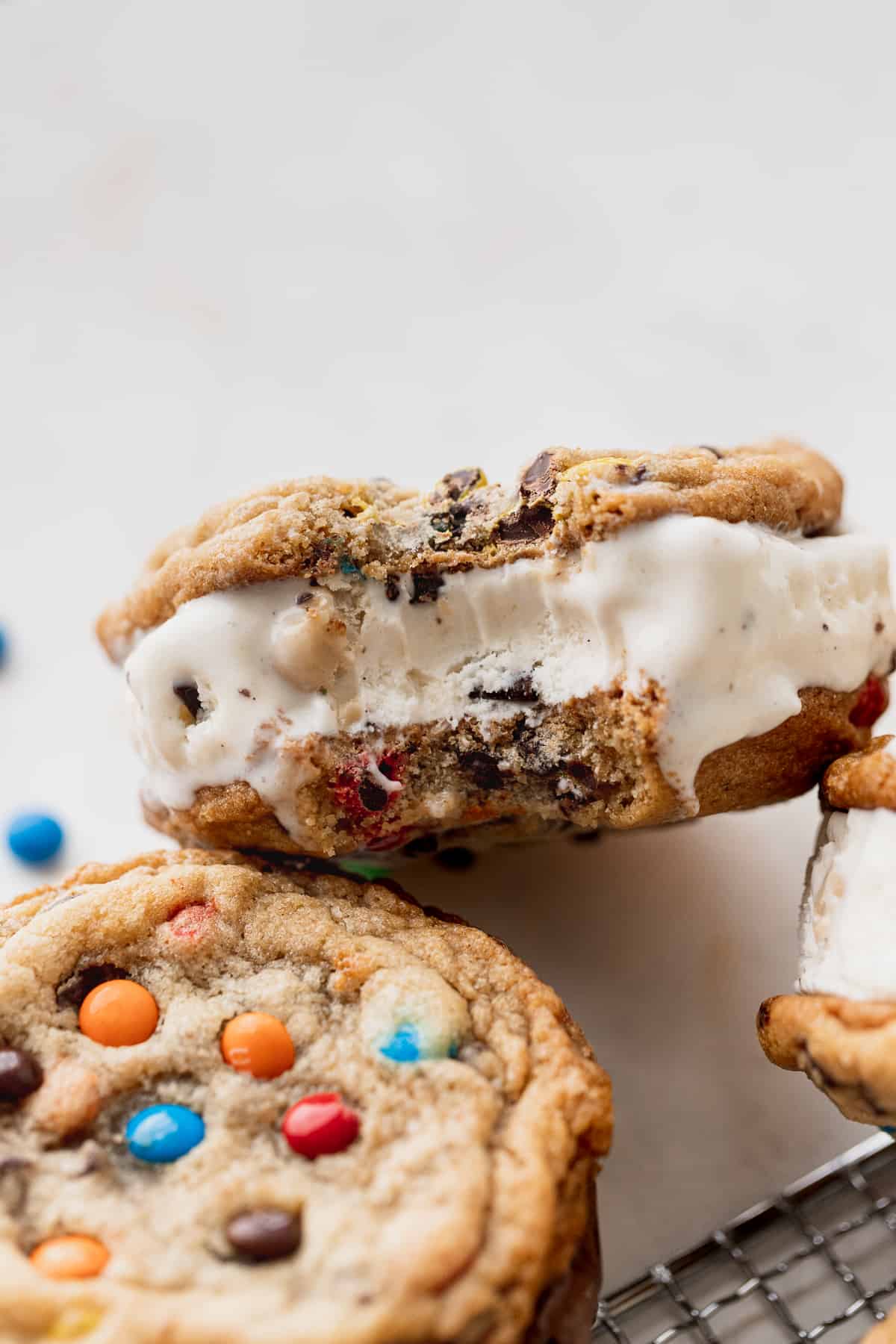 Bite missing from m&m cookie ice cream sandwiches.