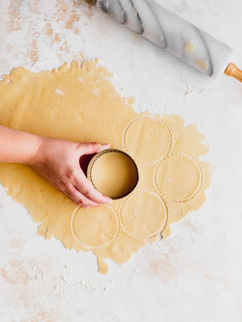 Cutting circles out of dough.