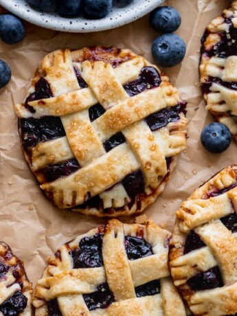 Close up of mini blueberry pies.