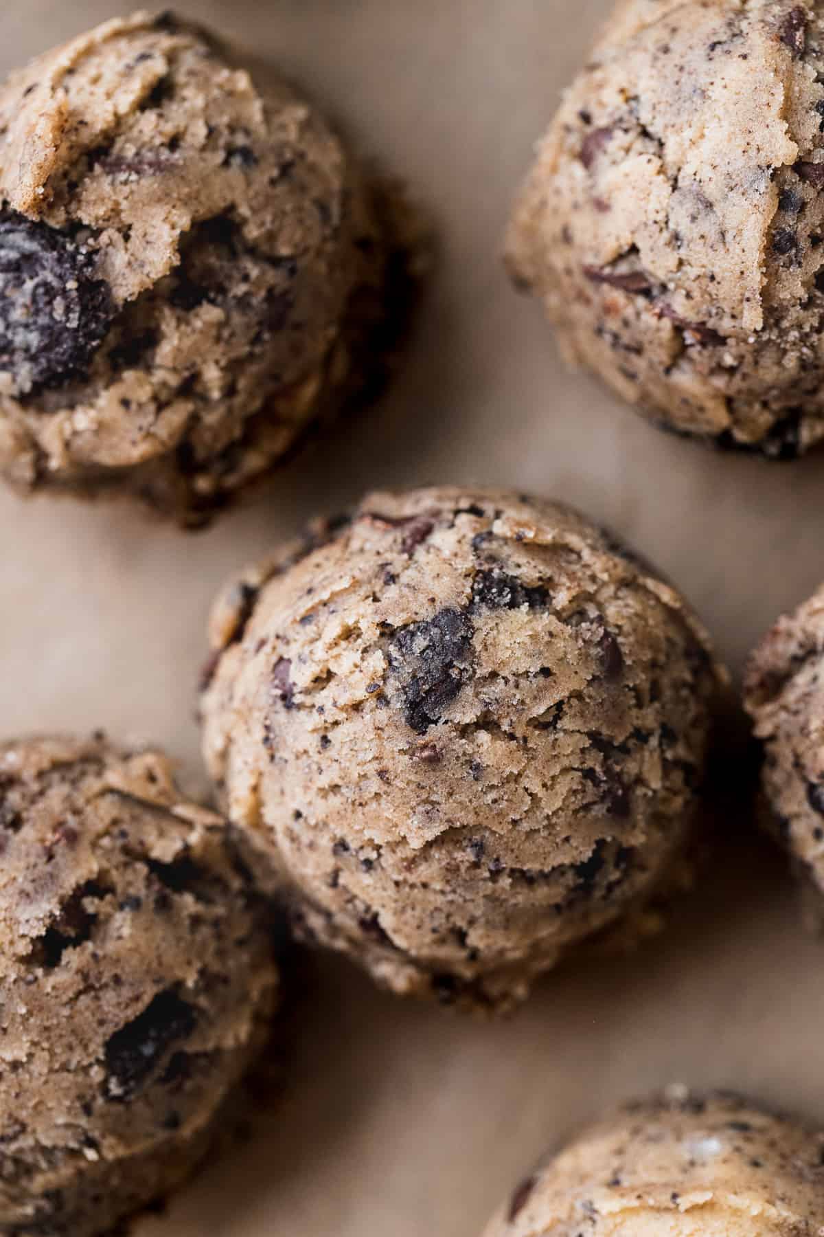 Cookie dough balls on parchment paper.