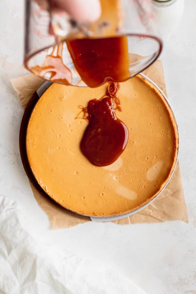 Pouring caramel on top of cheesecake.