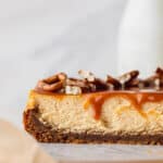 Caramel cheesecake with caramel dripping down.