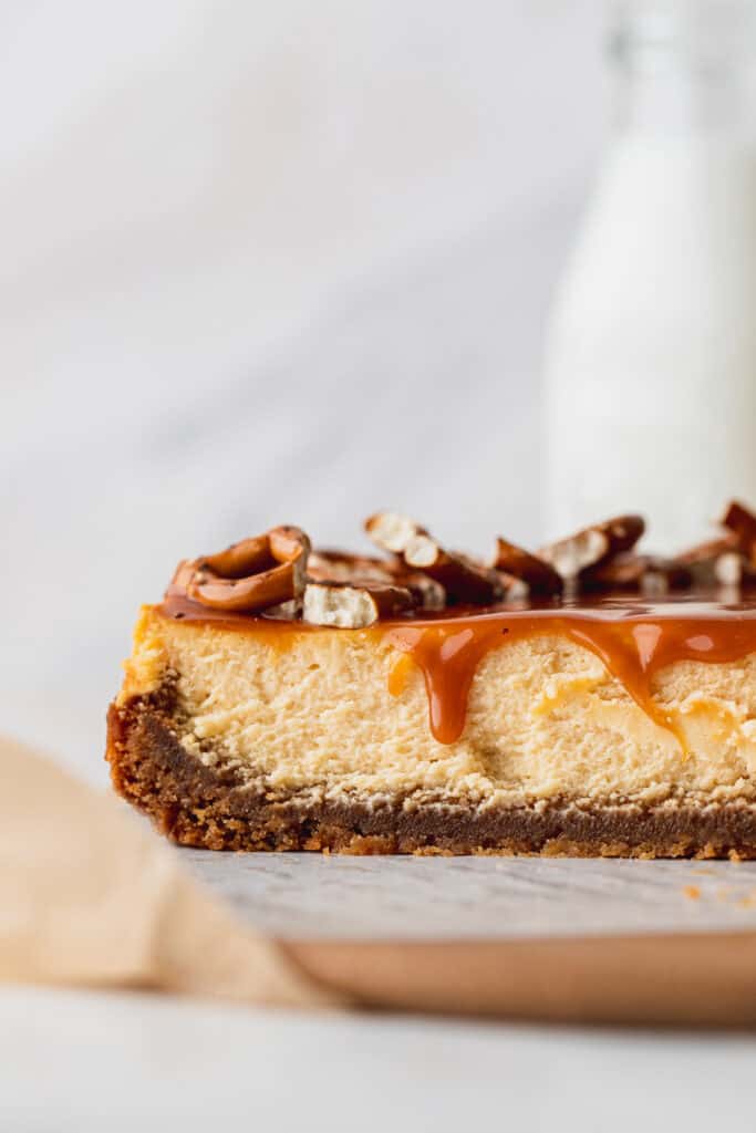 Caramel cheesecake with caramel dripping down.