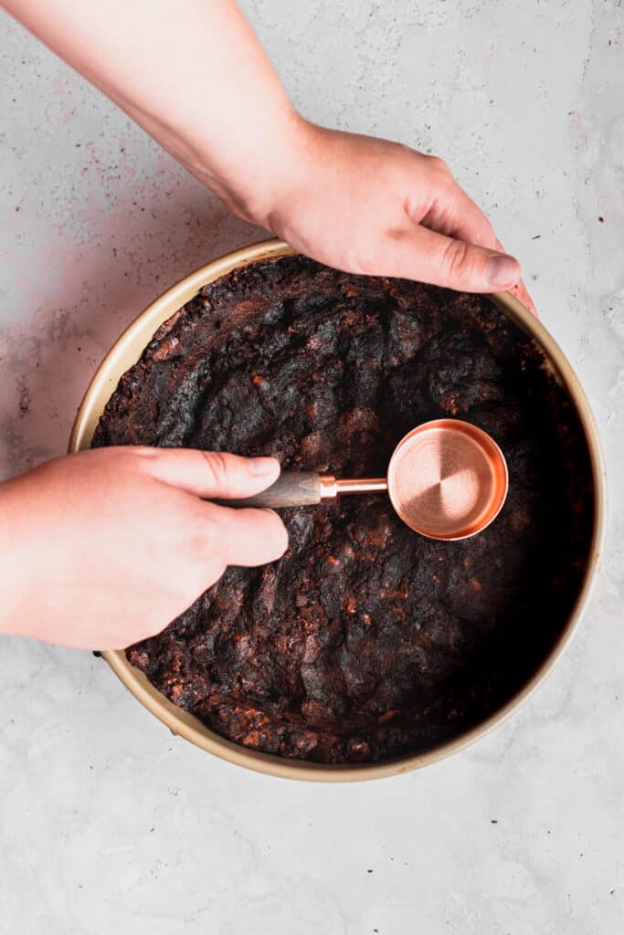 Pressing brownies in the pan.