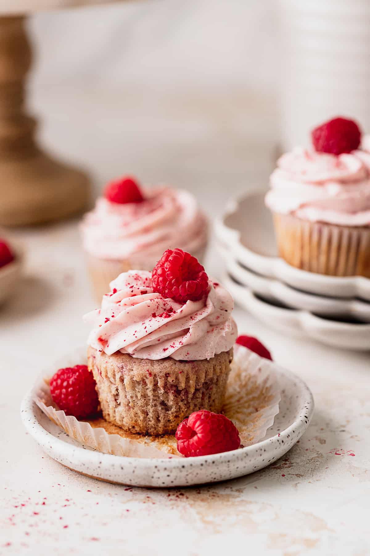 Raspberry cupcake on a plate.