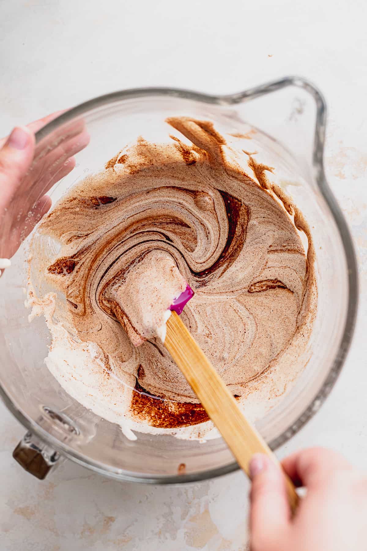 Mixing brownie batter in glass bowl.