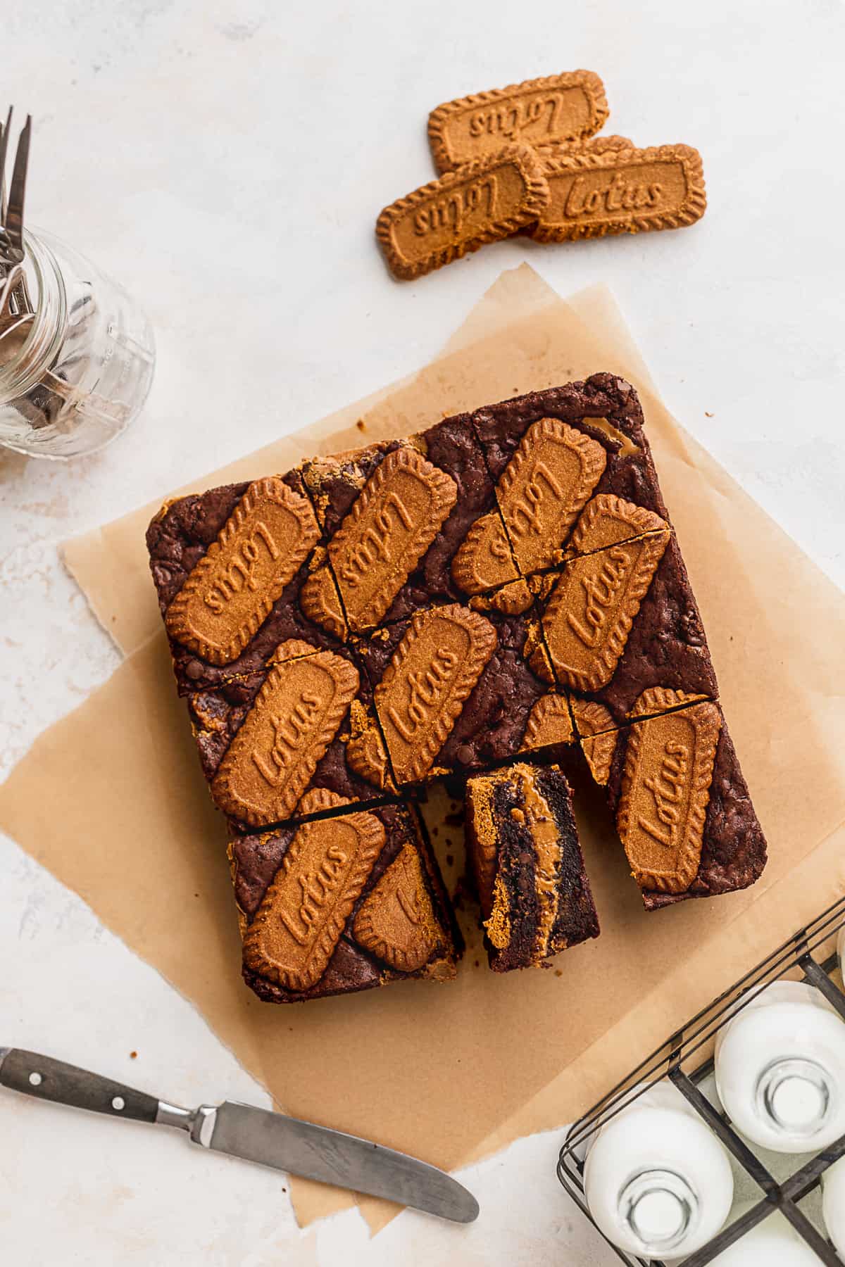 Biscoff brownies on parchment paper with one side sticking up.