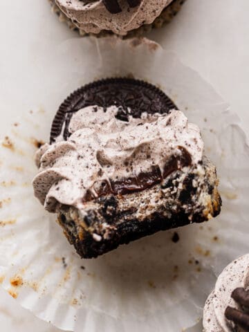 A bite missing from mini Oreo cheesecakes.