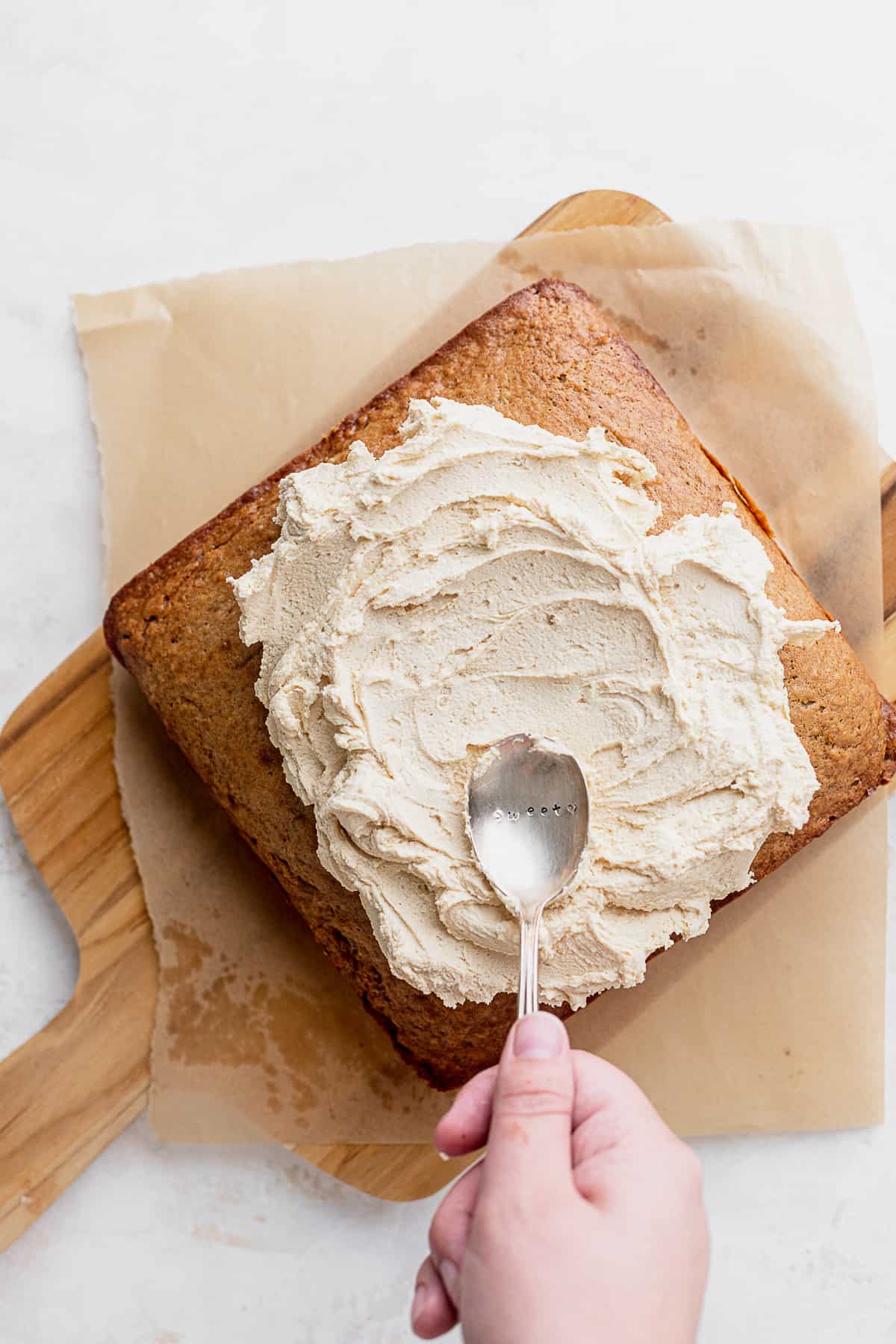 Spreading frosting on top of cake.