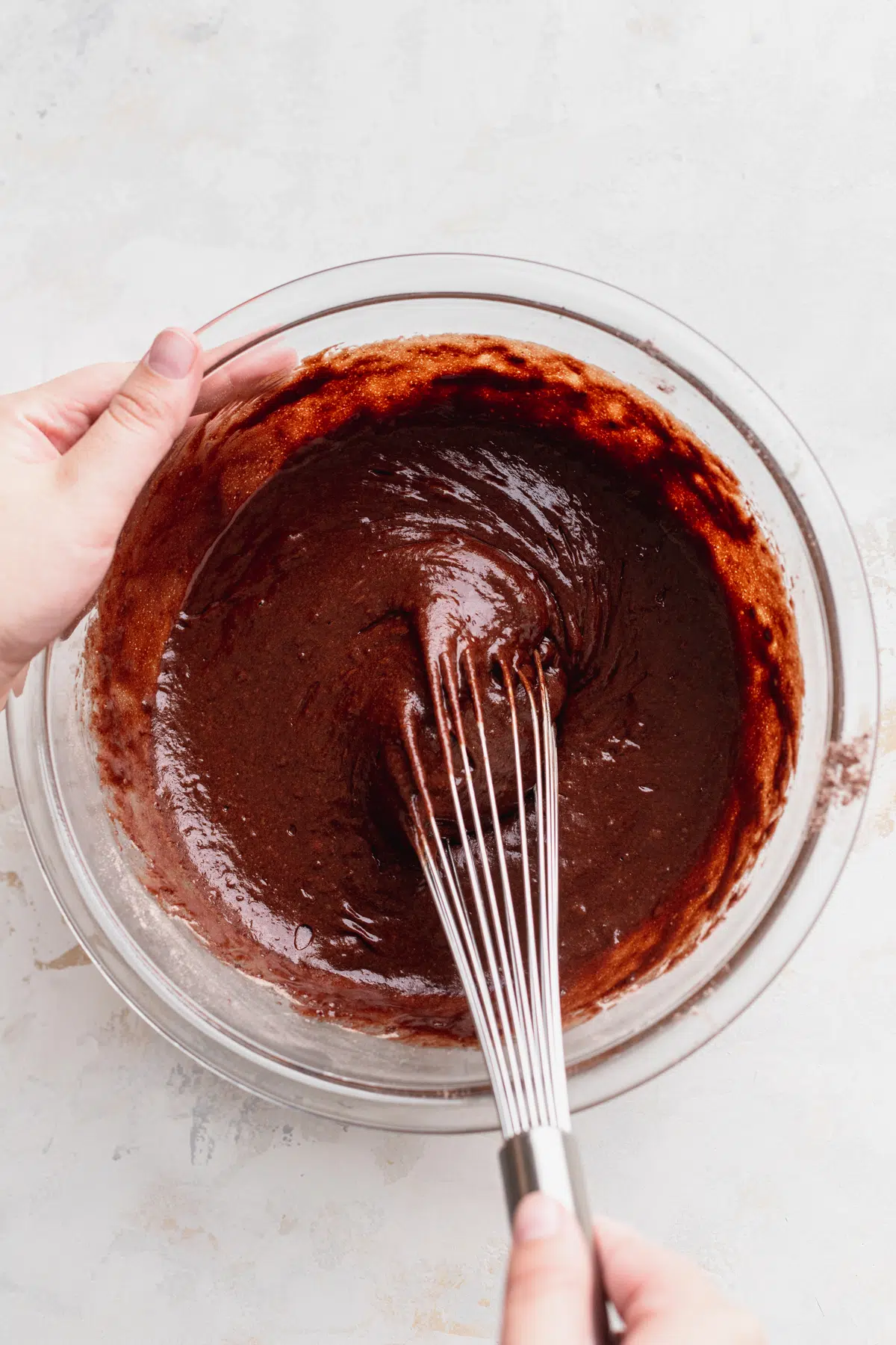 Chocolate cake batter in glass bowl.