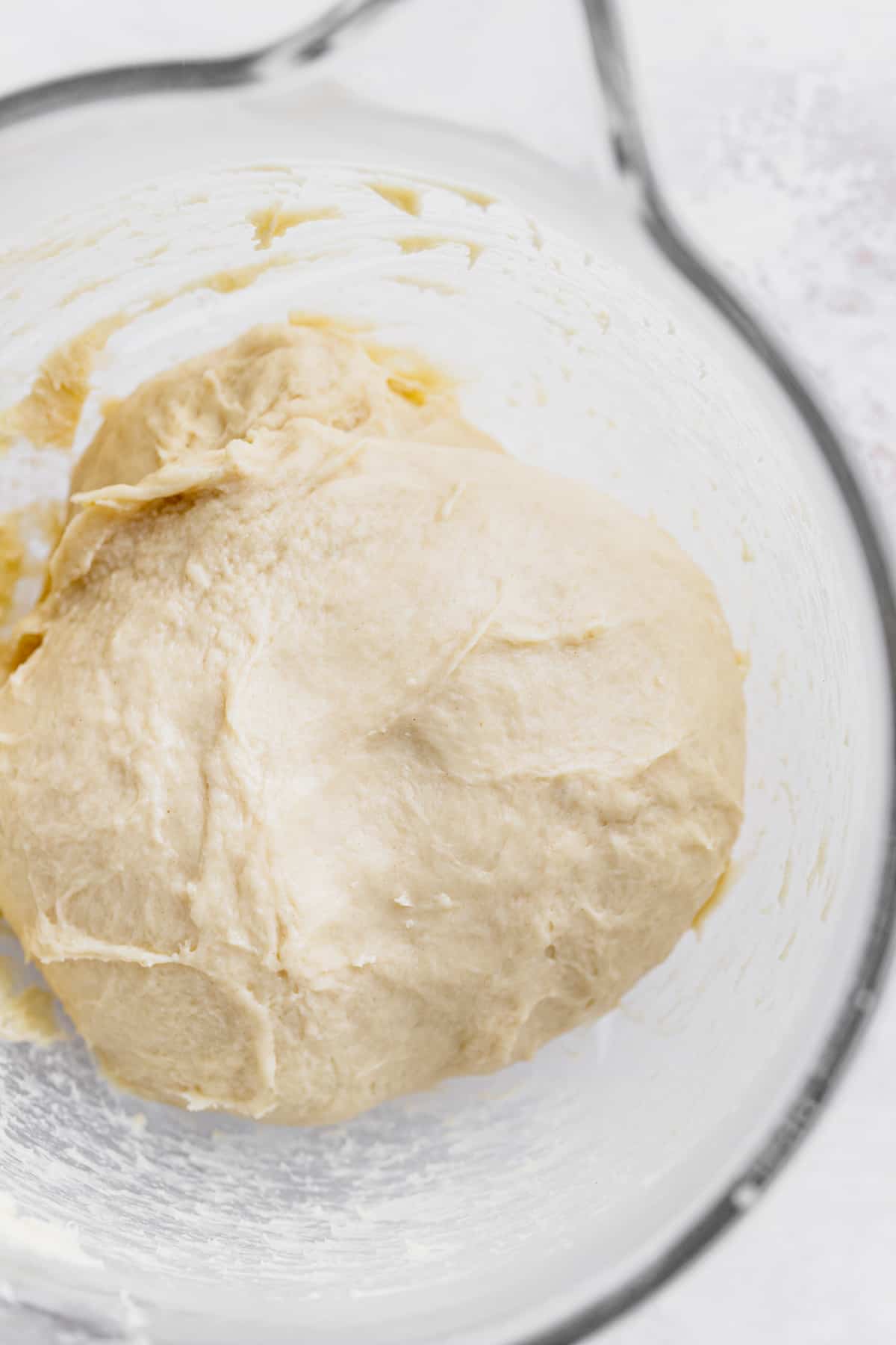 Dough in a glass bowl.