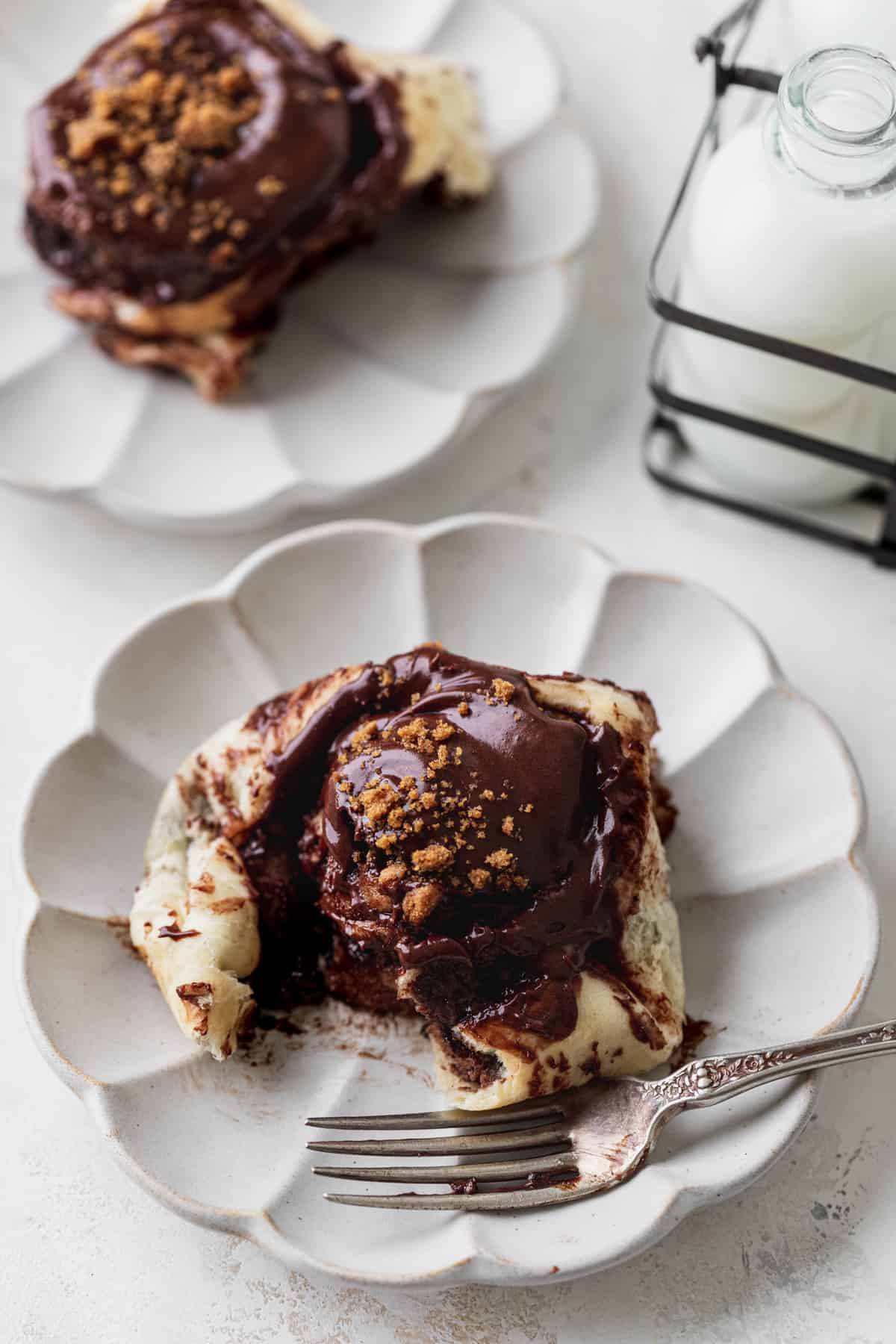 Rolls on a plate with a fork.