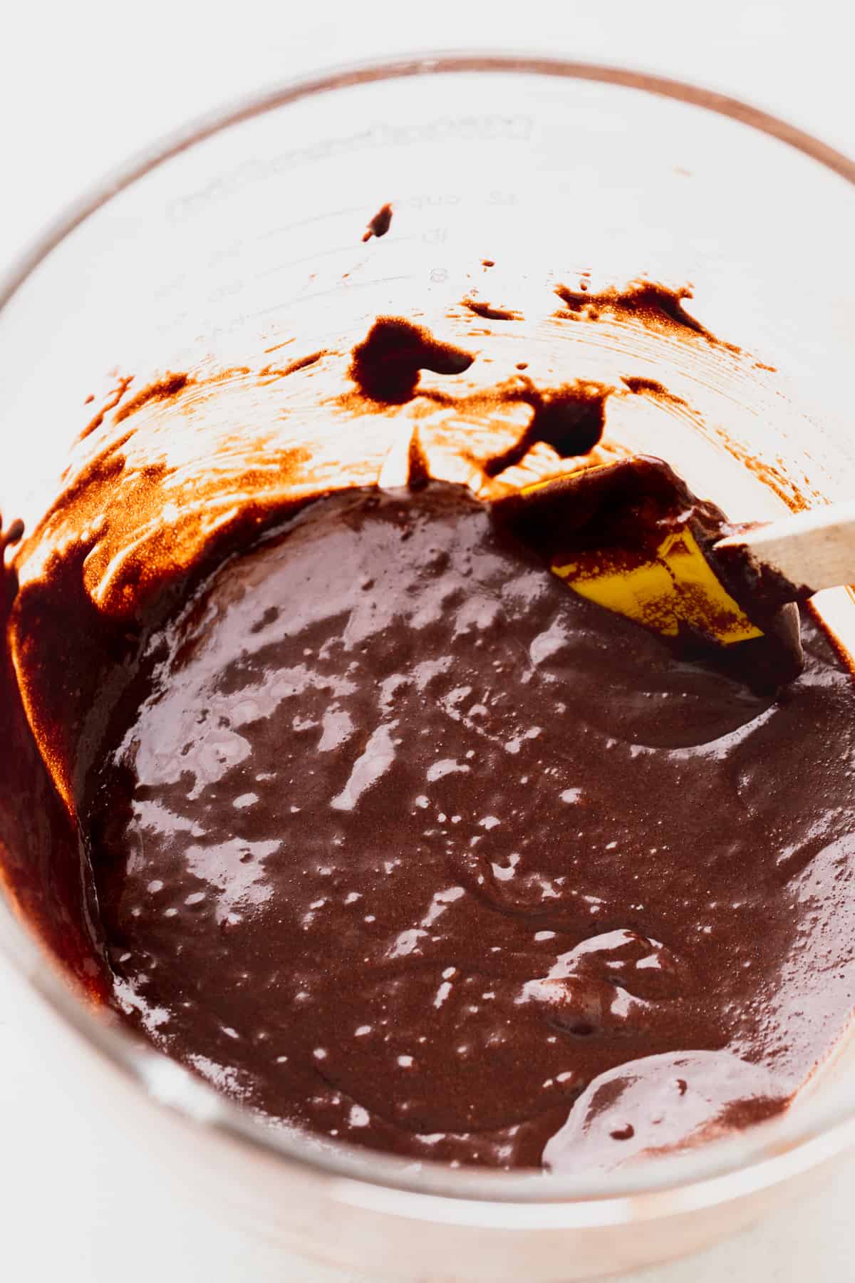 Brownie batter in a glass bowl.