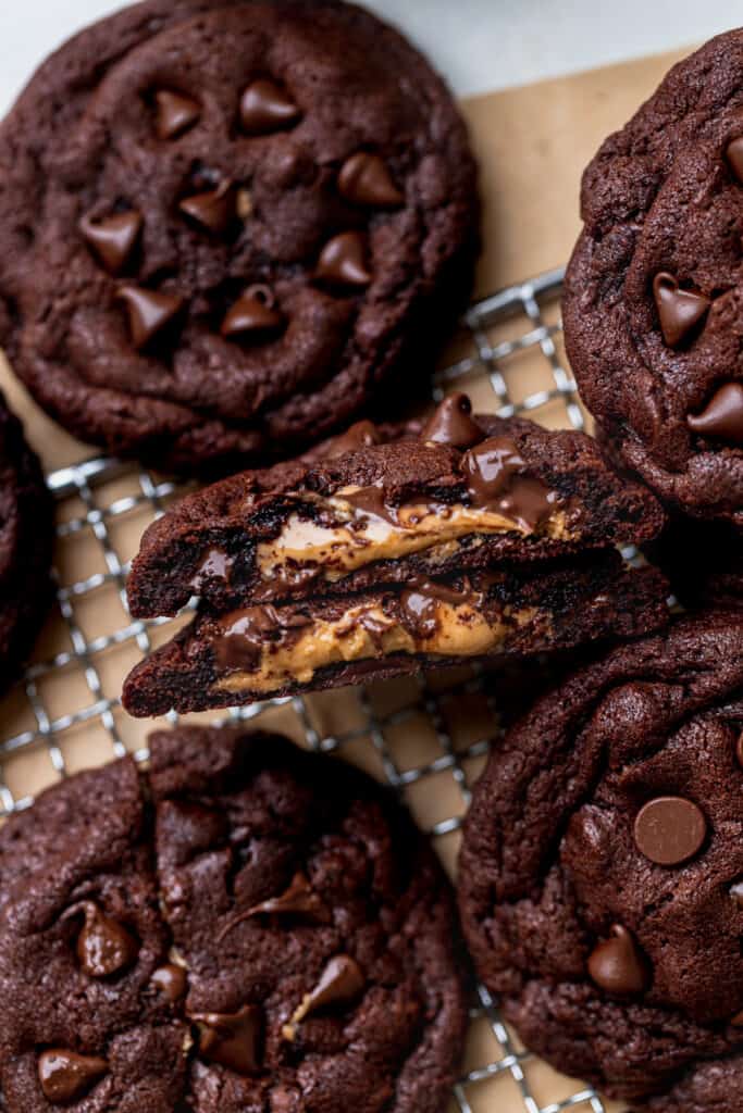 Chocolate peanut butter stuffed cookies on a wire rack.