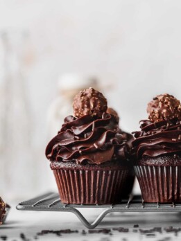 Chocolate fudge cupcakes on a wire rack.