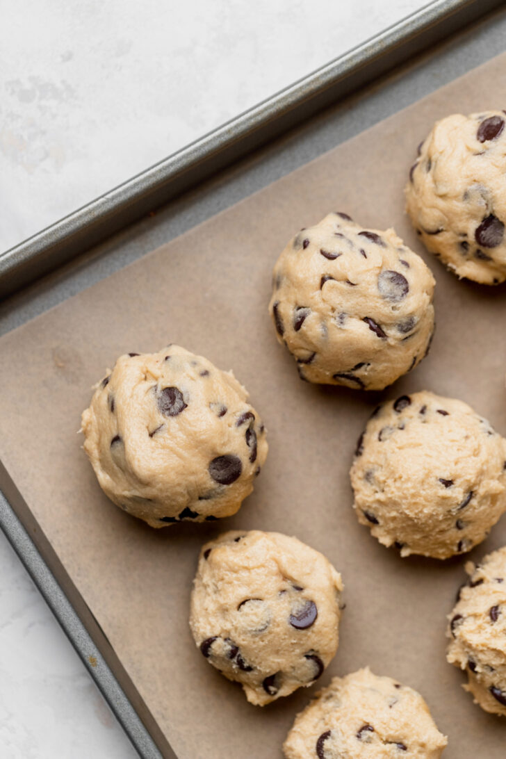 Cookie dough balls on a cookie sheet.