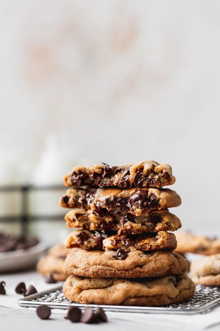 Stack of caramel chocolate chip cookies split in half.