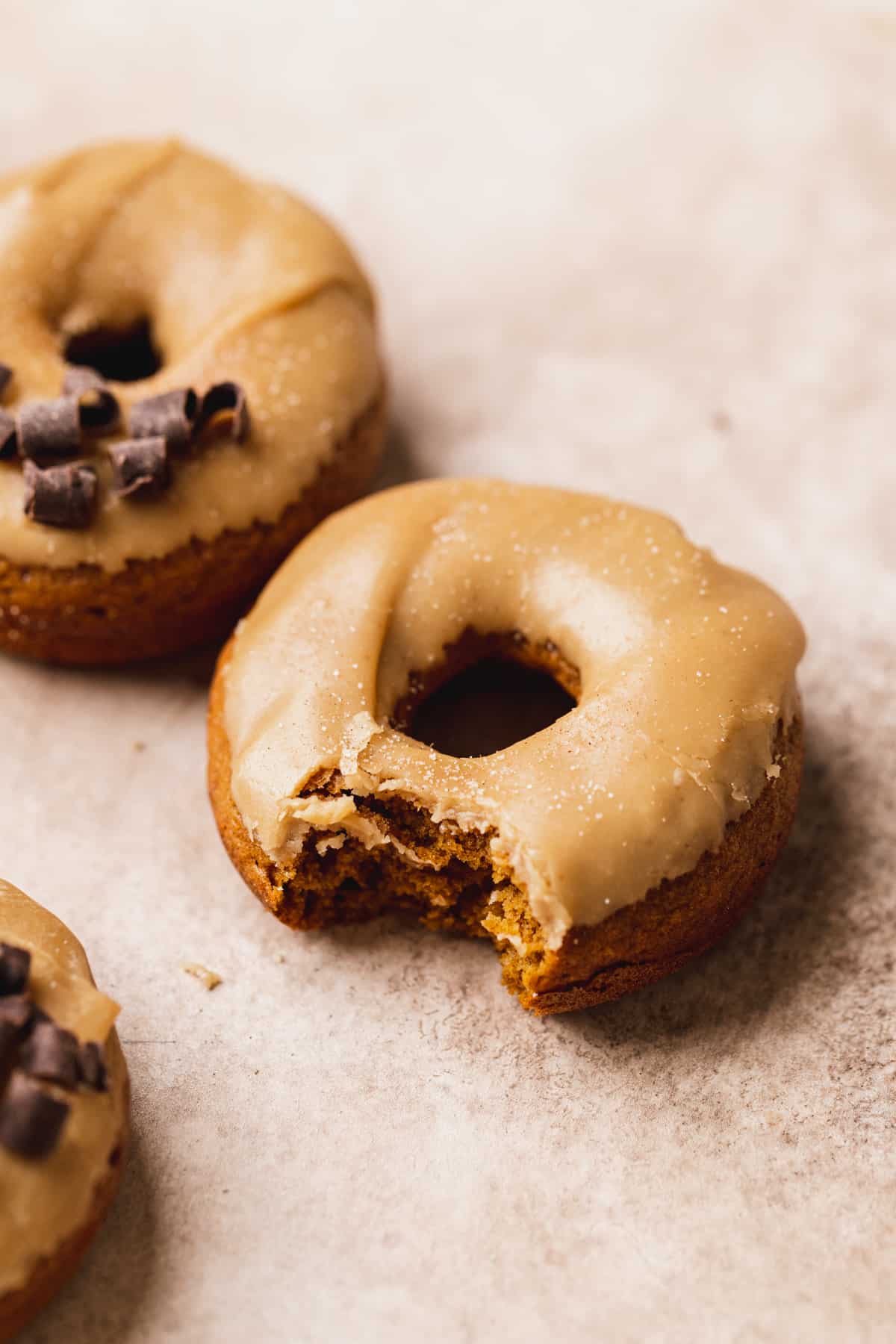 A bite missing from pumpkin donut.