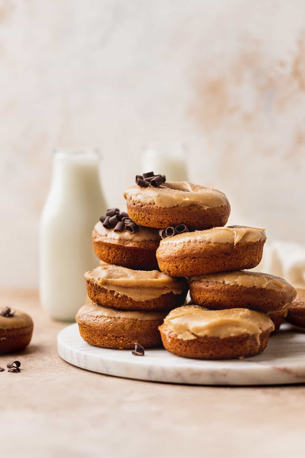 Stack of pumpkin donuts with maple glaze.