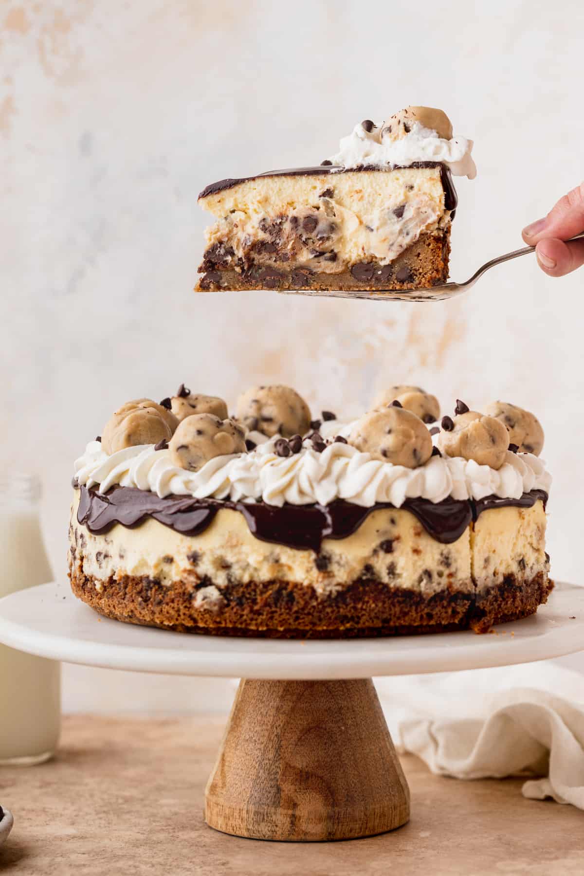 Taking a slice out of chocolate chip cookie dough cheesecake.