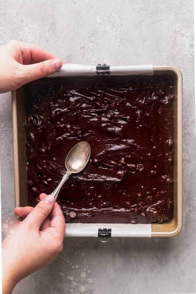 Spreading the brownie batter in the pan.