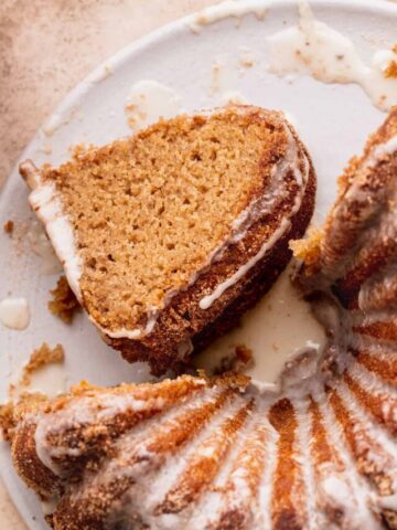 Slice of apple cider donut cake next to cake.