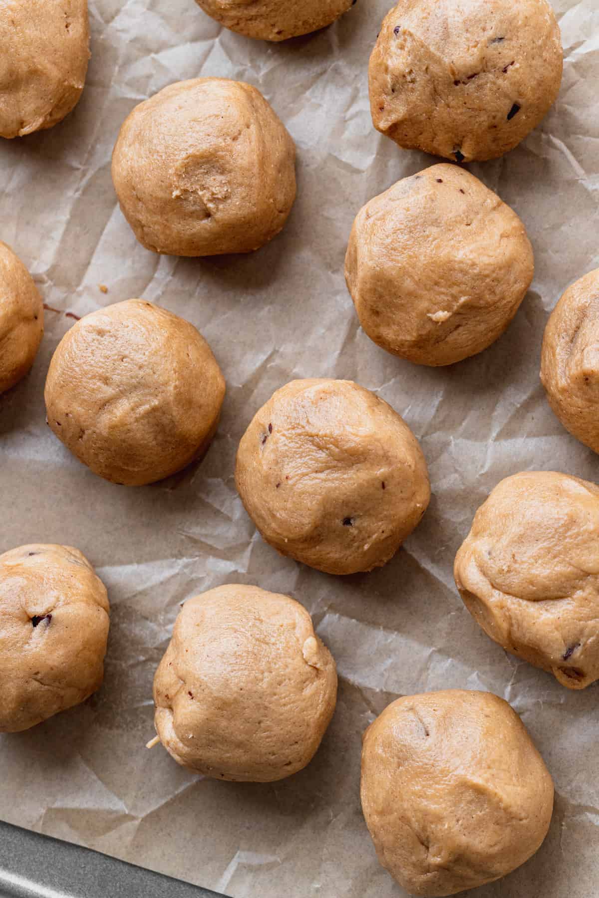 Rolled cookie dough balls on a cookie sheet.