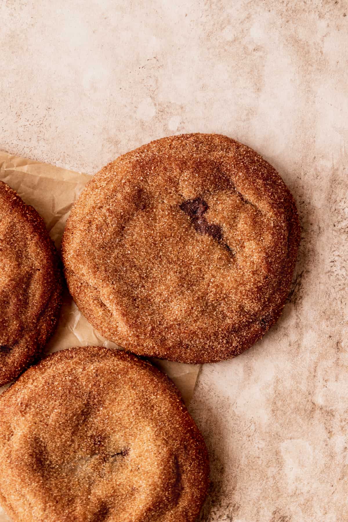 Churro chocolate stuffed cookies on parchment paper.