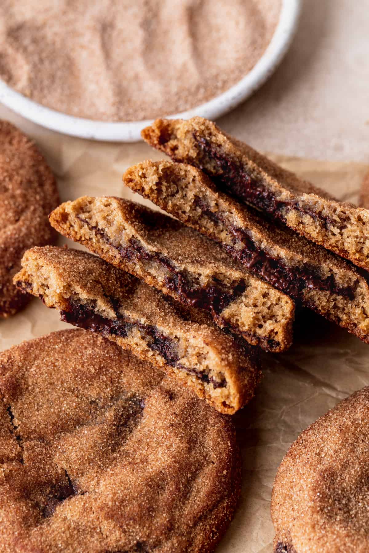 Two cookies split in half showing the gooey chocolate.