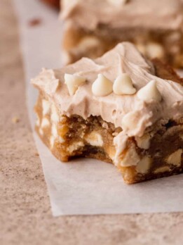 Bite missing from white chocolate cinnamon blondies.