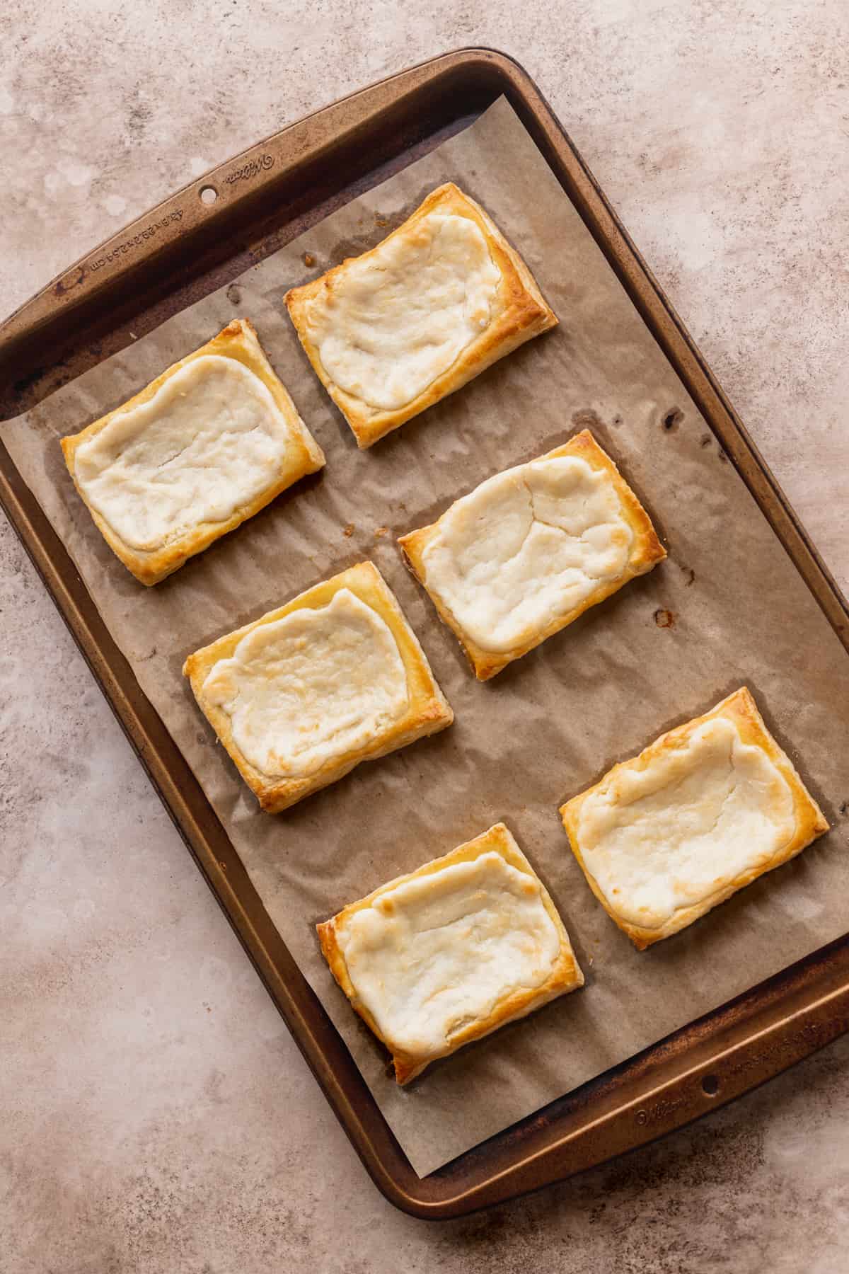 Baked pastry on top of cookie sheet.