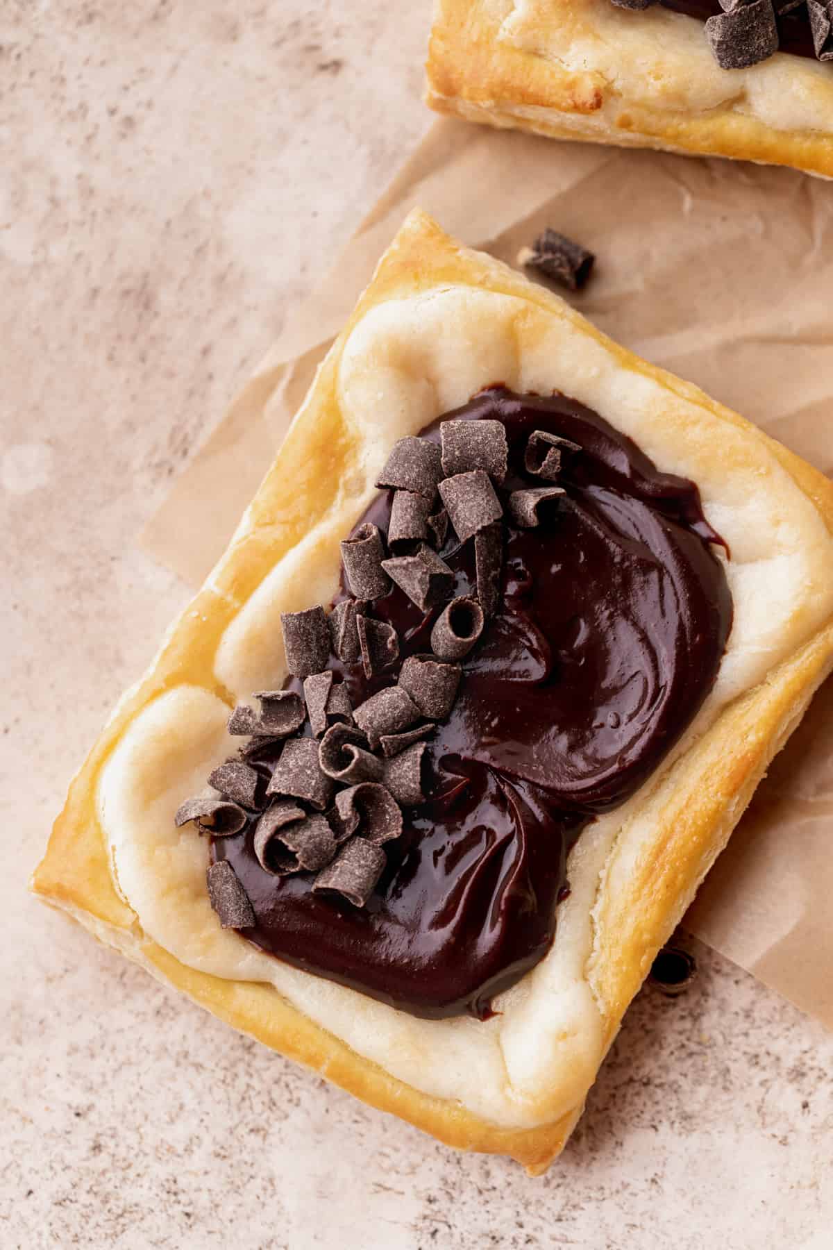 Chocolate cream cheese danish with chocolate curls on top.