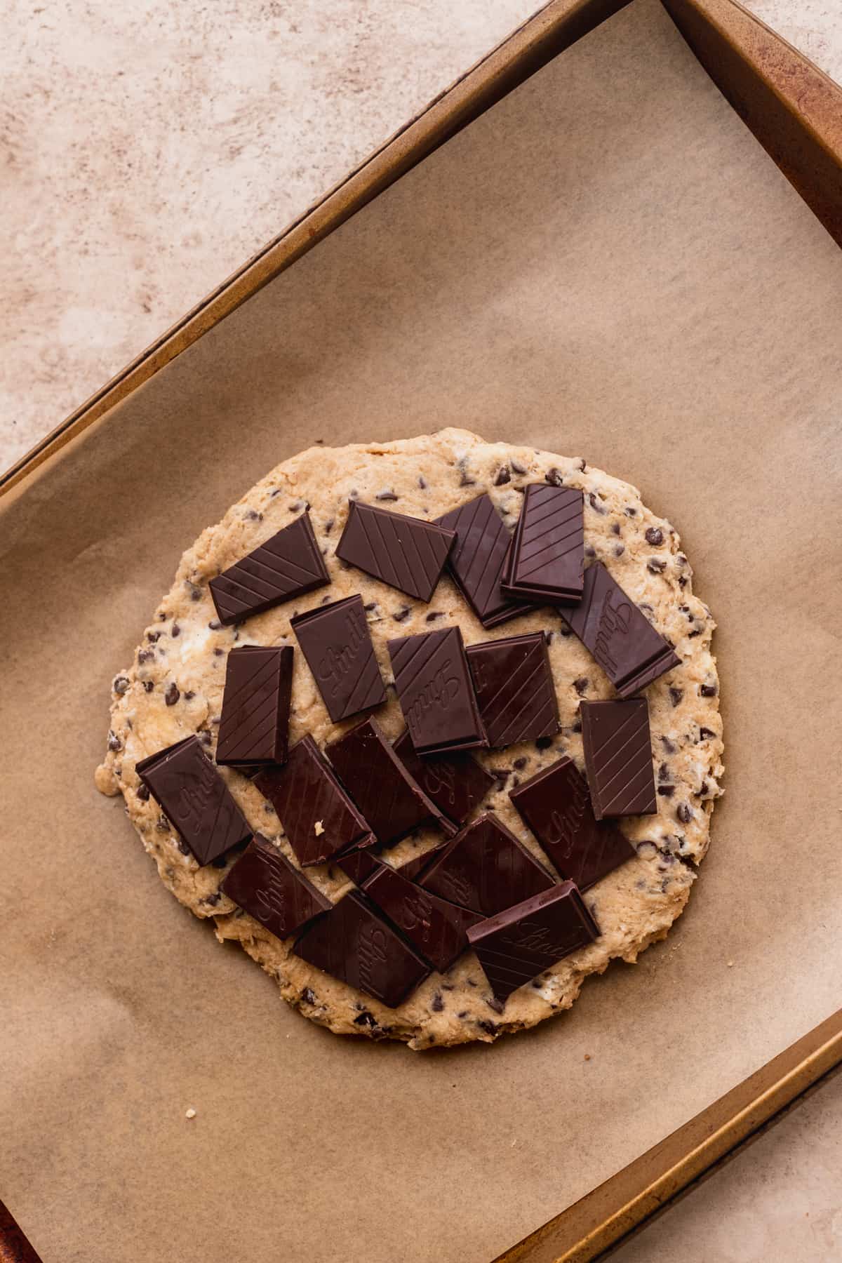 Chocolate pieces on top of scone dough.