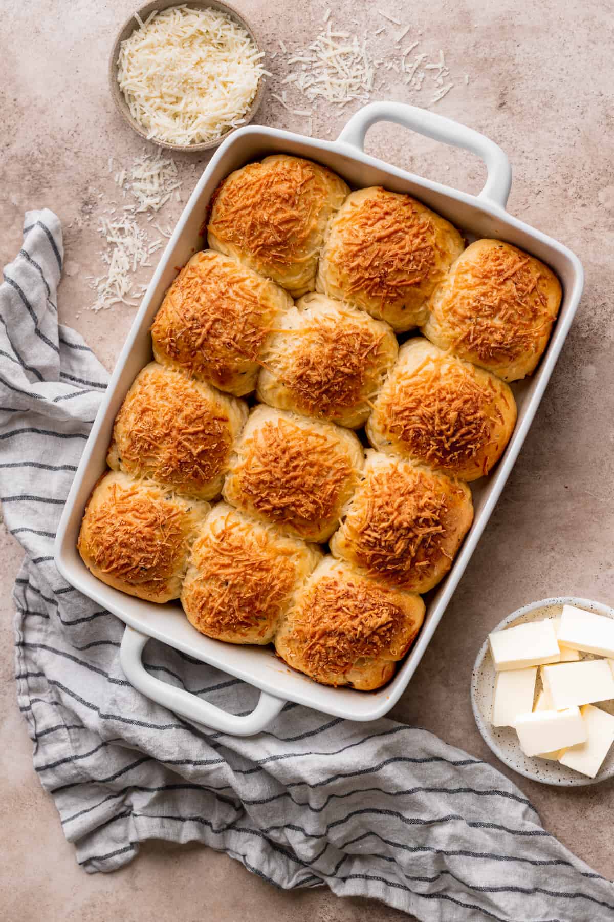 Baked fluffy cheddar cheese rolls in a pan.