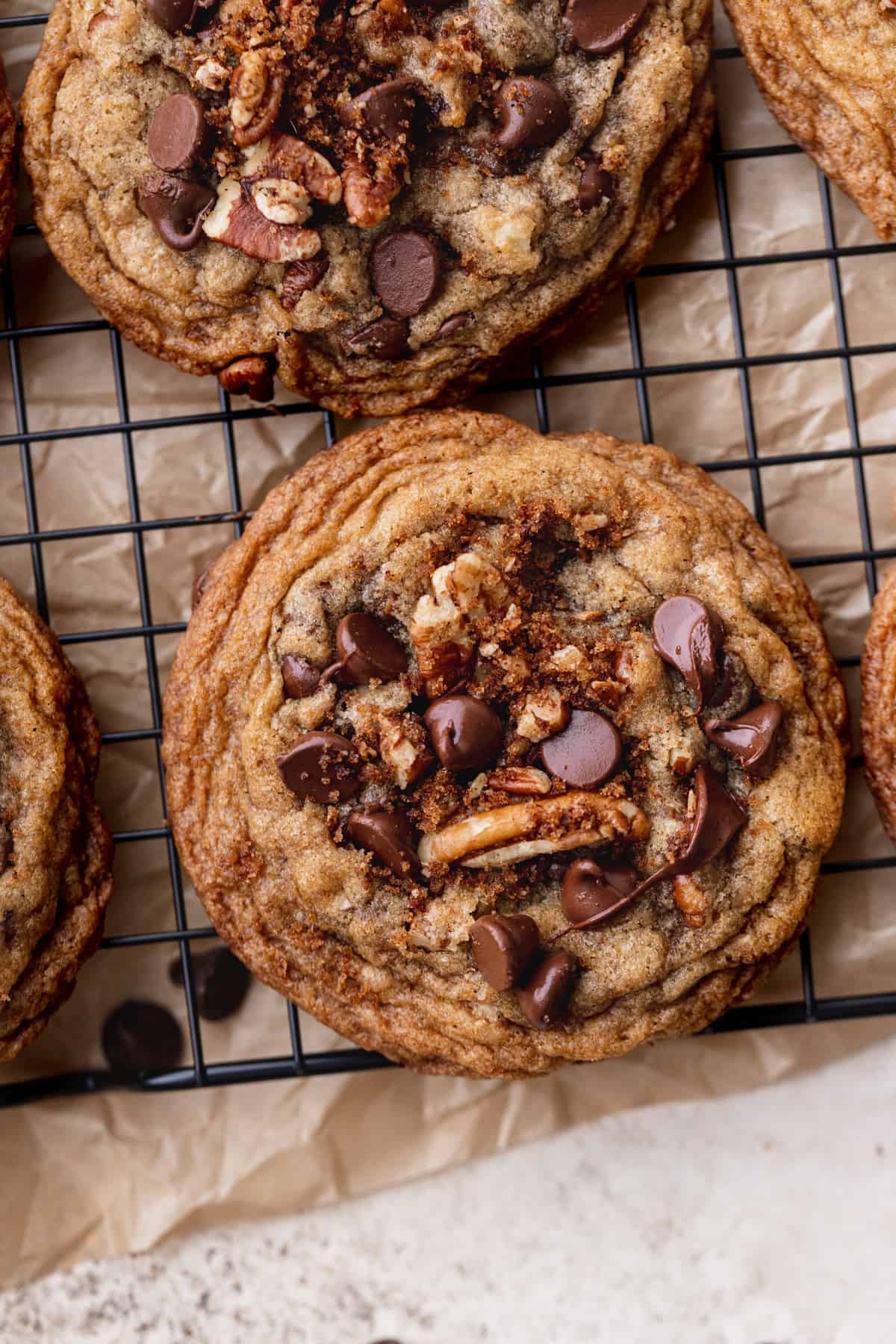 Extra pecans on a cookie on a cookie sheet.