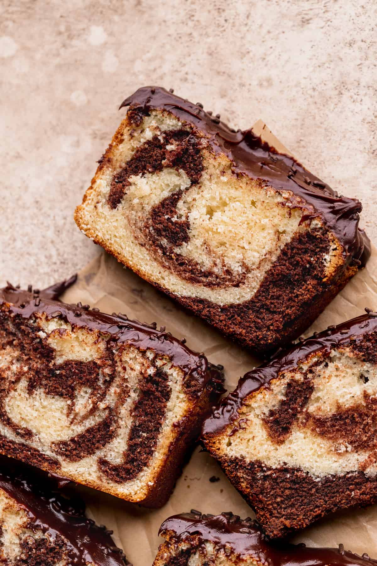 Chocolate marble loaf cake slices showing frosting.